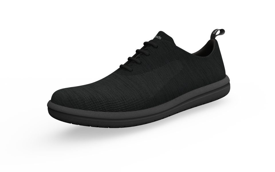 Black Biopods classic sneakers shown from the front profile, highlighting their sleek design and durable canvas material.