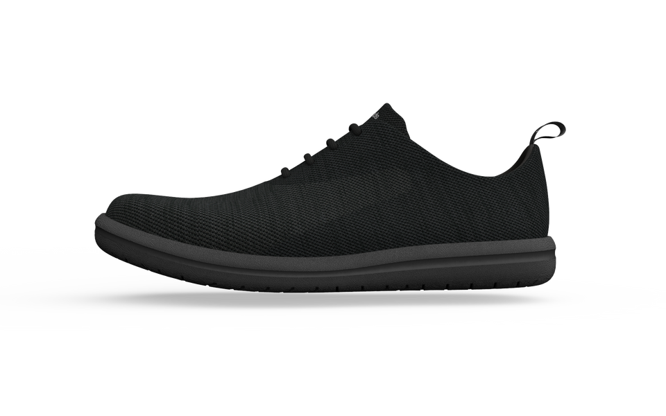 Black Biopods classic sneakers shown from a side view, featuring a sleek design and comfortable standard fit.