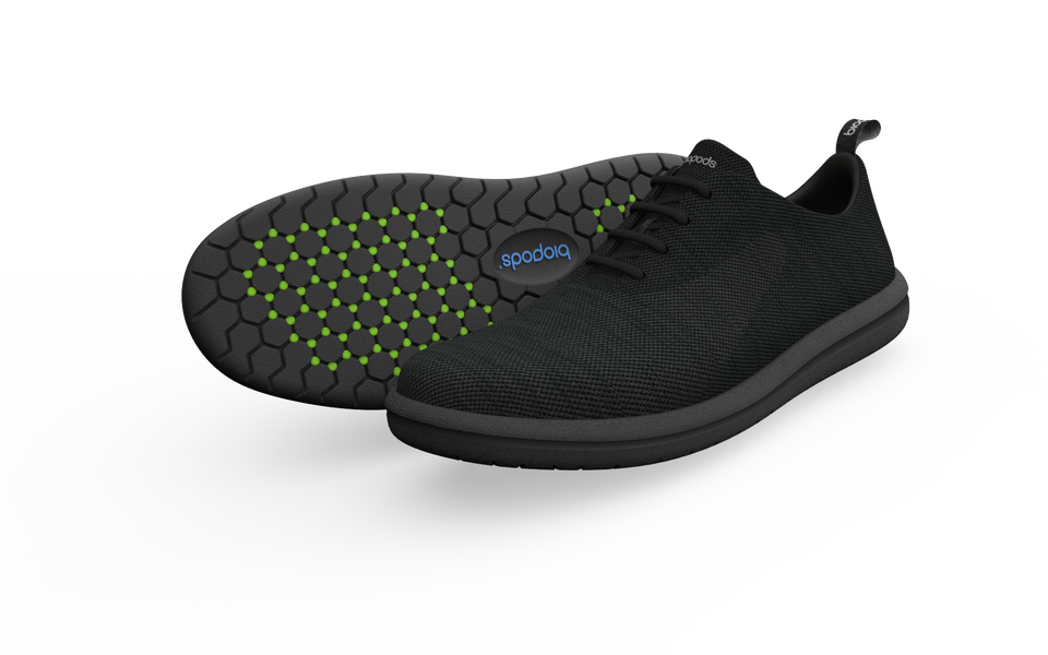 Pair of black Biopods wide classic sneakers shown in profile, featuring a sleek design and cushioned sole.