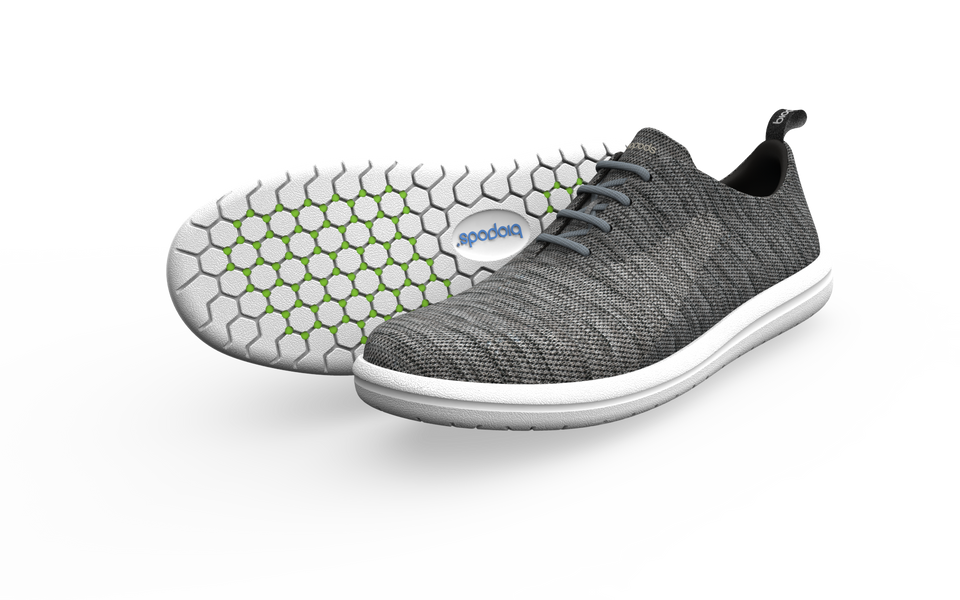 Pair of grey Biopods narrow classic sneakers shown from the side with a slight shadow, highlighting their sleek design and slim fit.