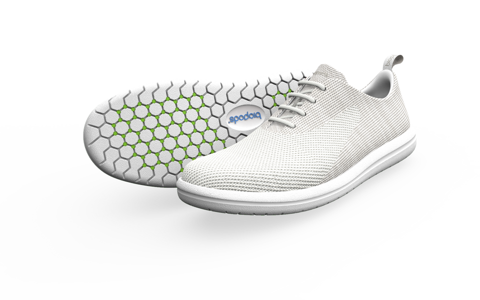 Pair of white Biopods Classic Sneakers with a side profile view showing their sleek design and white laces.