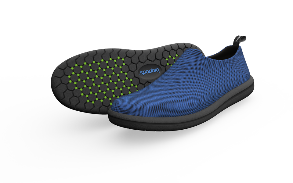 Pair of Biopods narrow urban sneakers in sapphire blue with sleek design and textured sole, displayed on a neutral background.